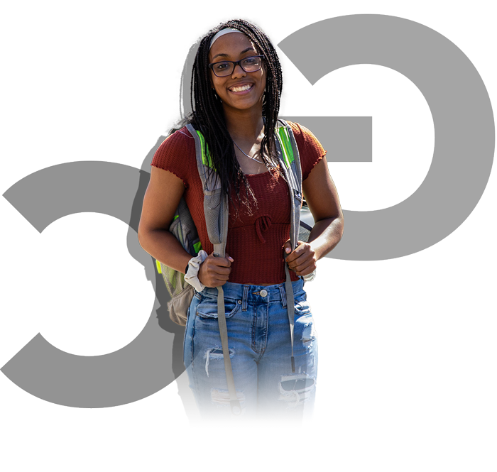 Image of female student wearing a backpack and smiling